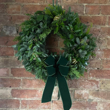 Load image into Gallery viewer, an all green Christmas wreath with a luxury velvet bow with pagen origins bringing joy life and renewal through winter
