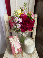 Load image into Gallery viewer, Decorative setup with flowers, candle, and gift box of chocolates on a wooden surface at bits and buds florist in leighton buzzard Bedfordshire offering same day delivery.