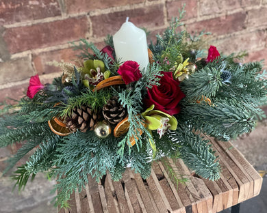Small flower arrangement for Christmas table with a candle and decorations. red or white roses from Bits and Buds florist Leighton Buzzard