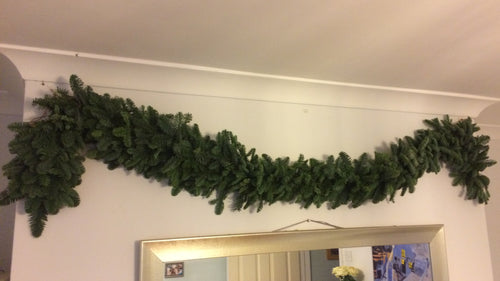 a fresh pine Christmas garland adorning a fireplace. Available to buy by the metre from bits and buds florist Leighton Buzzard. DIY christmas decorations