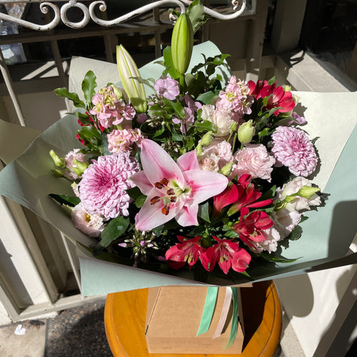 Bouquet of flowers on a table outdoors at Bits and Buds florist Leighton Buzzard. With scented lily flowers available for delivery and online shopping 