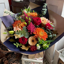 Load image into Gallery viewer, an autumnal bouquet with seasonal fall flowers and red roses in a rustic natural setting from luxury florist Bits and Buds in Leighton Buzzard for Bedfordshire delivery
