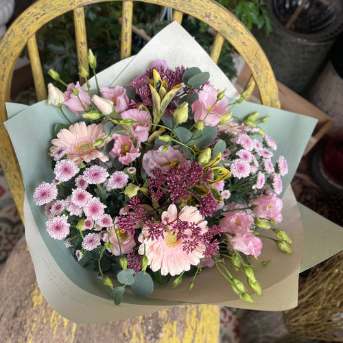 a pretty pastel pink bouquet displayed at the rustic florist shop bits and buds in leighton buzzard new baby birthday valentine's pink flower bouquet