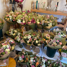 Load image into Gallery viewer, Table with various flower bouquets in a store setting at bits and buds florist leighon buzzard bedfordshire luxury gifts for mother's day

