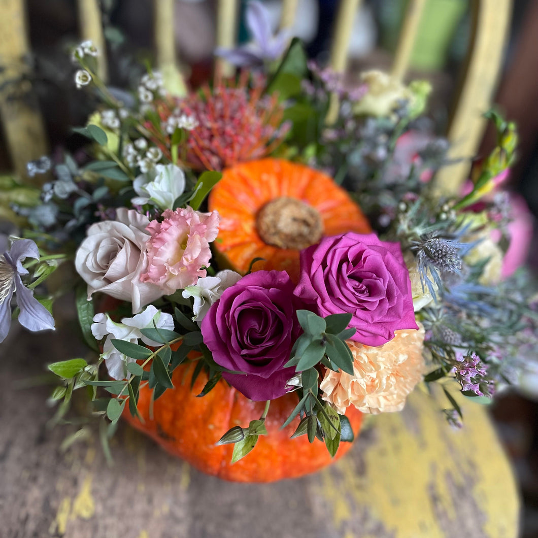 floral pumpkin in an orange halloween pumpkin to make a spooky seasonal decoration at a flower workshop at bits and buds florist leighton buzzard