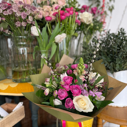 bouquet of roses in a yellow bucket at the flower shop