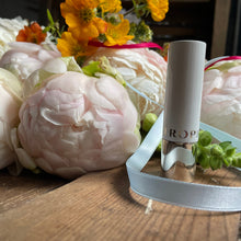 Load image into Gallery viewer, tropic lip balm infront of peonies and british flowers at bits and buds florist leighton buzzard flower workshop
