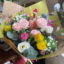 Load image into Gallery viewer, Bouquet of flowers with pink, yellow, and white flowers on a green paper background. bits and buds florist leighton buzzard
