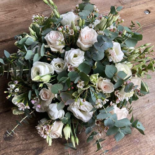 small funeral posy of white and cream roses and eucalyptus made plastic and foam free from bits and buds florist leighton buzzard