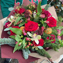 Load image into Gallery viewer, Bouquet of red roses fried oranges and other flowers on a brown paper background
